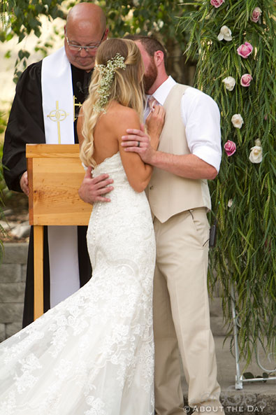 Bride and Groom kiss during ceremony at Shadow Lake Ranch