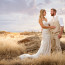 Bride and Groom pose in spectacular sunset