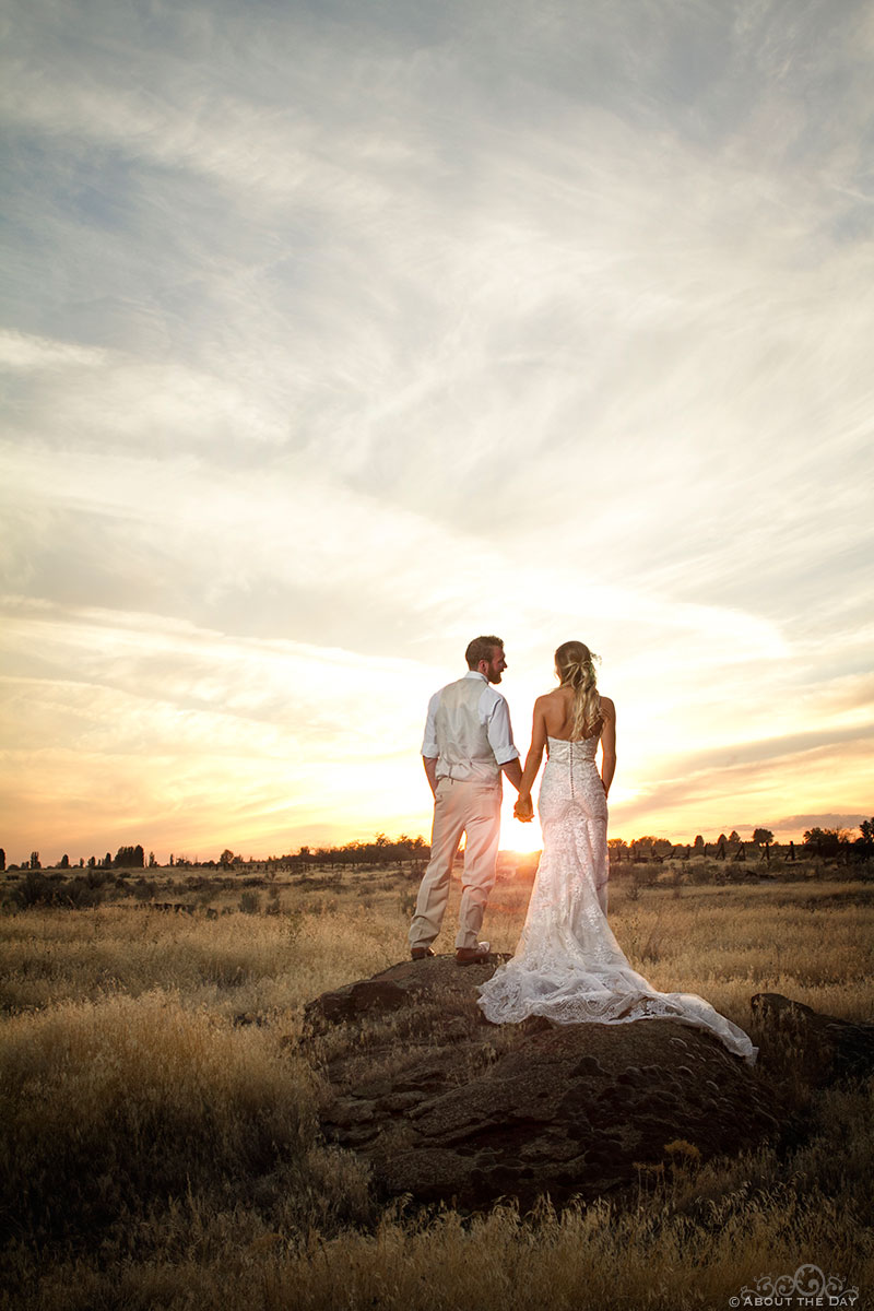 Bride and Groom pose in spectacular sunset at Shadow Lake Ranch