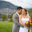 Bride and Groom cuddle with Bridge of the Gods in background on Thunder Island