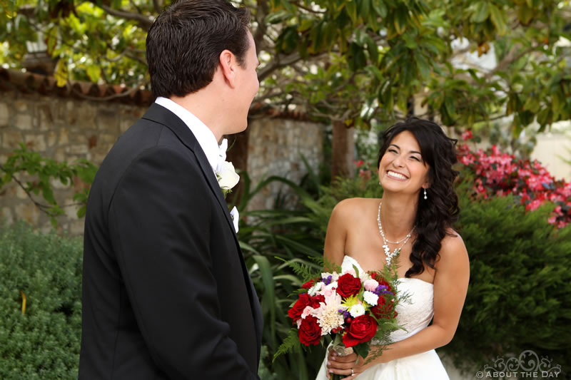 Groom turns to see smiling Bride