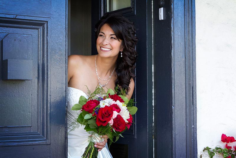 Bride peeks around corner to look at Groom