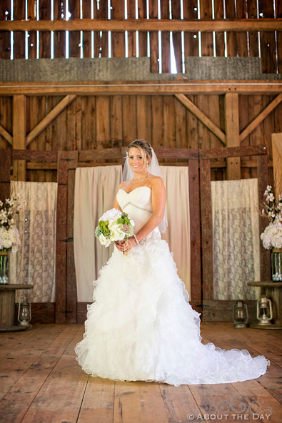 Bride poses in the barn at Youngs Dairy Farm in Auburndale, WI