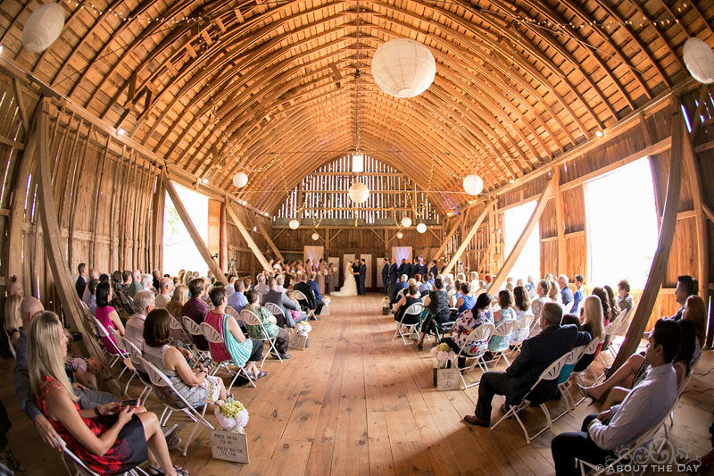 Fisheye view of a wedding ceremony in barn at Youngs Dairy Farm