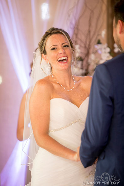 Bride laughs during vows