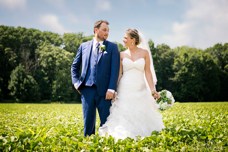 Bride and Groom strike a pose in soybean fields at Youngs Dairy Farm