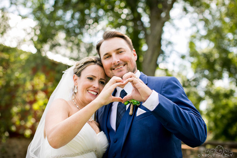 Bride and Groom make heart shape hands in Auburndale, WI