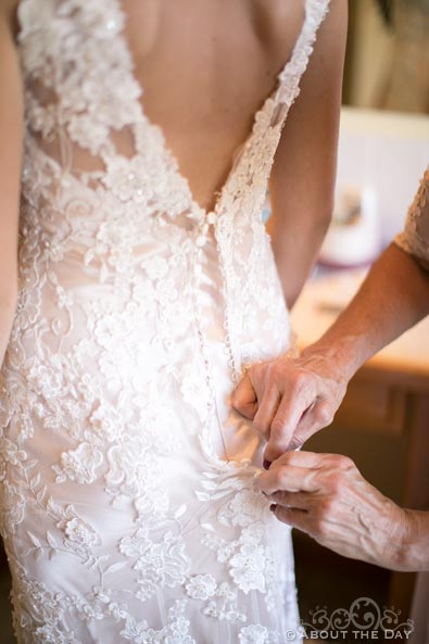 Beatuiful Bride's mother helps with dress