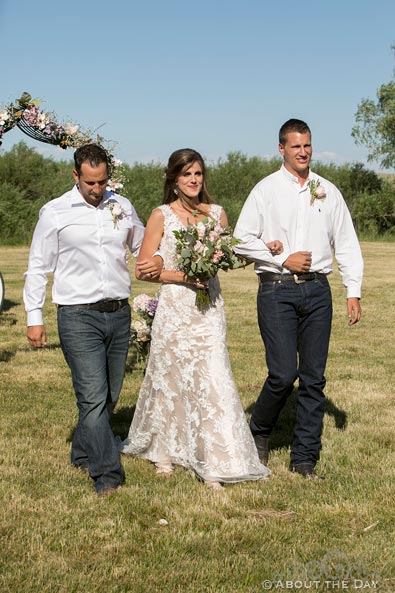 Beautiful Bride is escorted down the isle by her two brothers