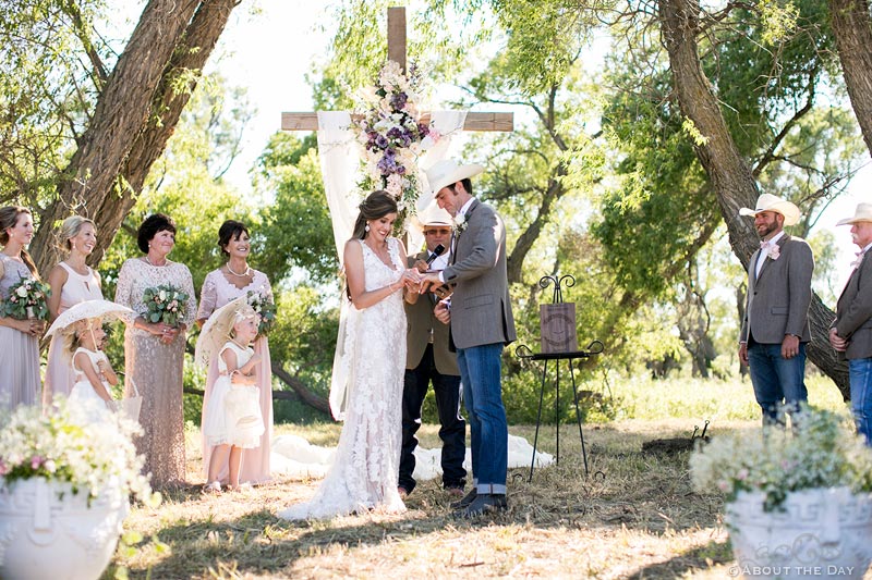 Bride and Groom exchange rings during country wedding ceremony