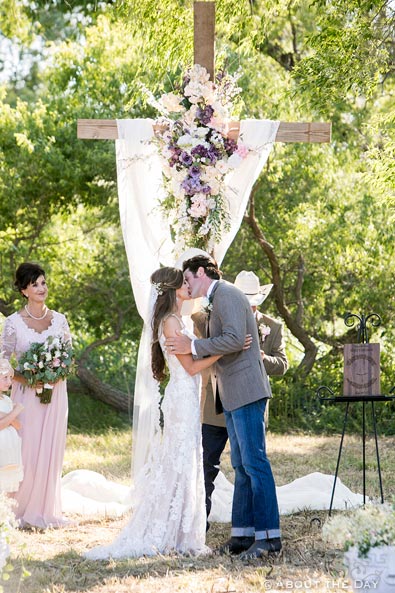 Bride and Groom kiss during country wedding ceremony