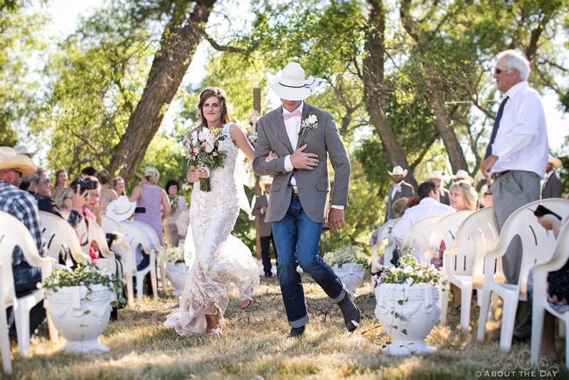 Bride and Groom dance down the isle at country wedding ceremony