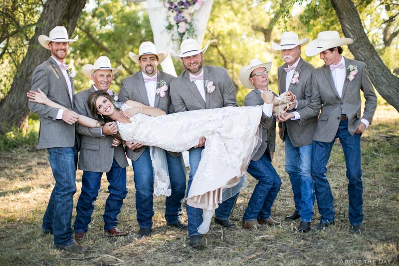 Lovely Bride being lifted by the Groomsmen