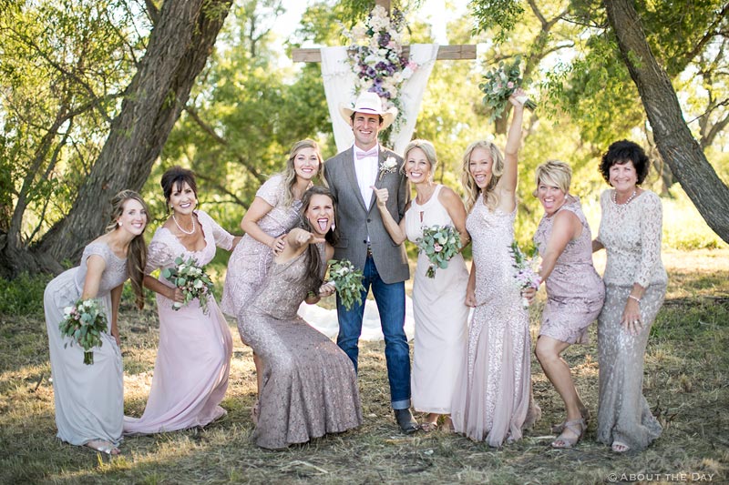 Cowboy Groom being goofy with the bridesmaids