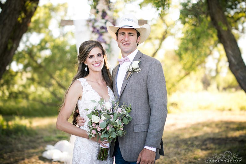 Bride and Groom pose at wedding ceremony site