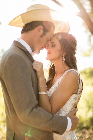 Cowboy Groomo and Beautiful Bride in sun flare