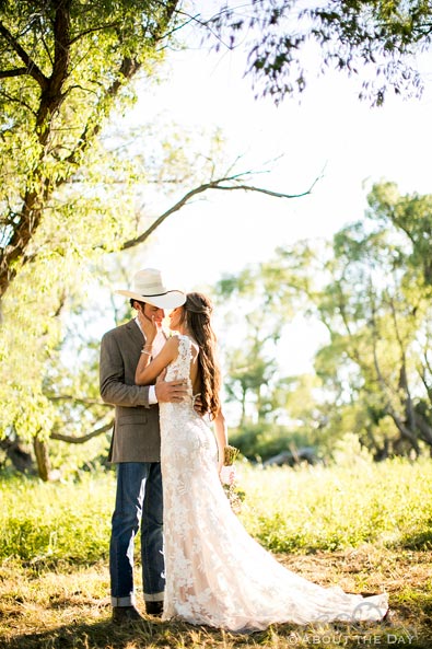 Bride and Groom kiss in sunlit trees