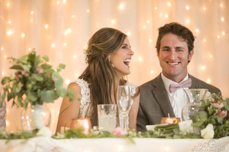 Bride and Groom laugh during toasts