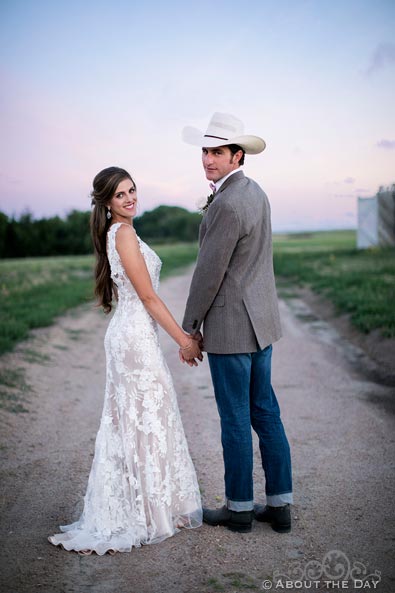 Bride and Groom turn to look back during walk at Haythorn Land & Cattle Co