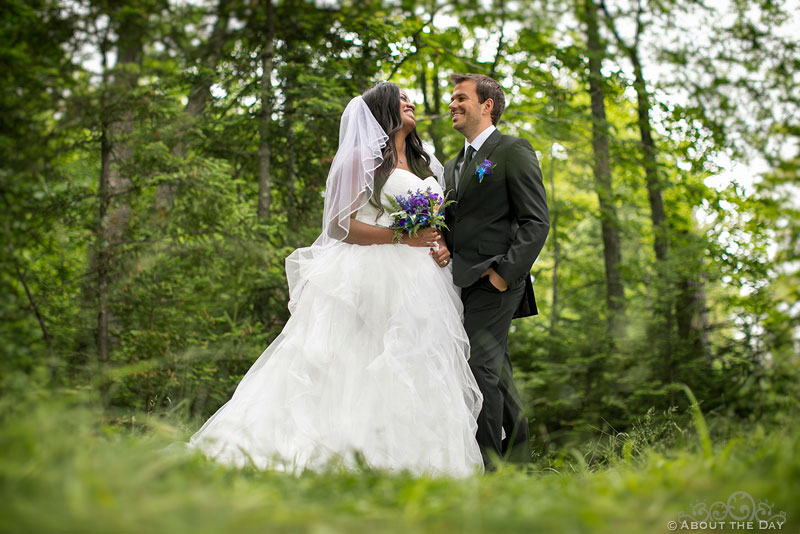Bride and Groom joking around in the woods near Manitowish Waters
