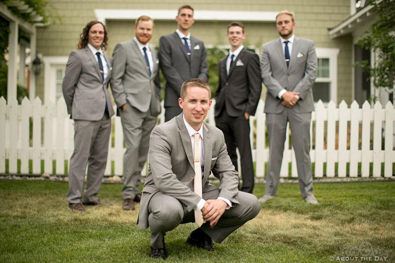 Chris and his groomsmen pose in front of a cottage