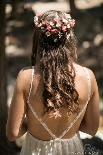 Brides hair woven with flowers from the back