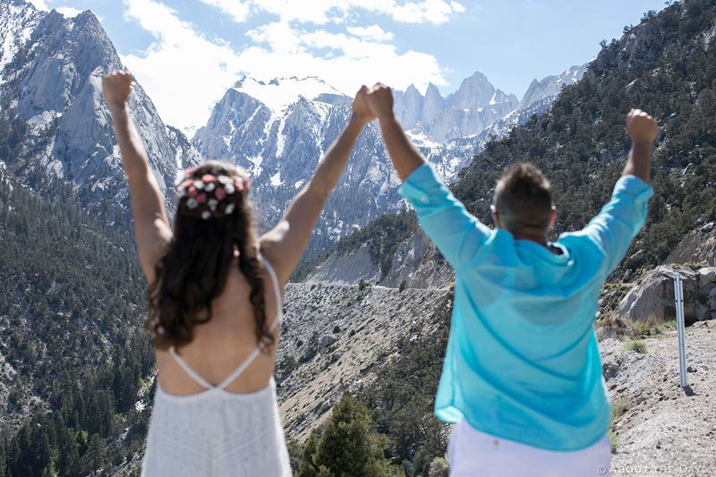 Wedding couple raises their arms with Mt Whitney in the background