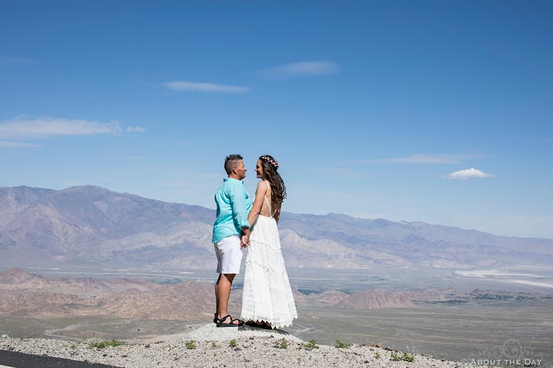 Brides look at each other with a view of the valley from Mt Whitney