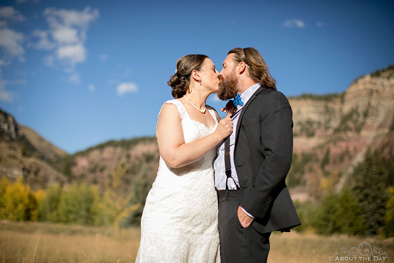 Bride and Groom kiss with Colorado Rockies in the background