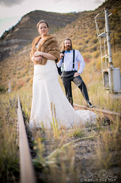 Bride and Groom stand in the railrod tracks at Minturn, CO
