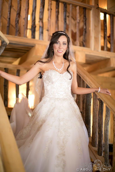 The Bride comes down the log cabin stairs in Platoro, CO