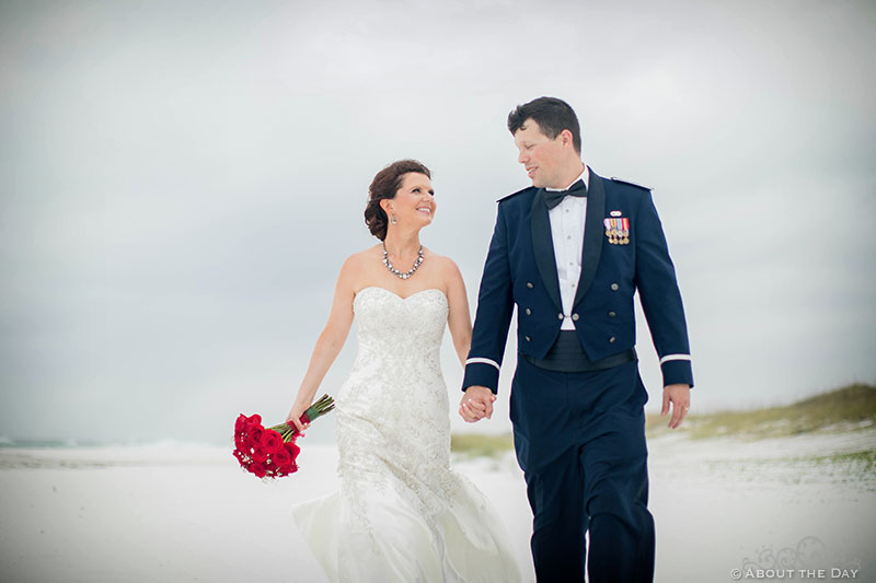 Josh and Rebecca walk along windswept Princess Beach in Destin, Fl