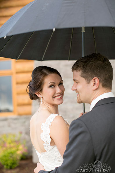 Bride poses under umbrella