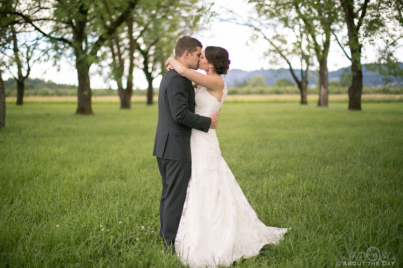 Bride and Groom kiss in the orchard