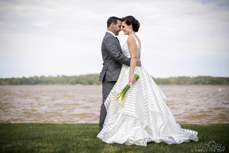 Bride and Groom stand at the edge of Lake Oconee
