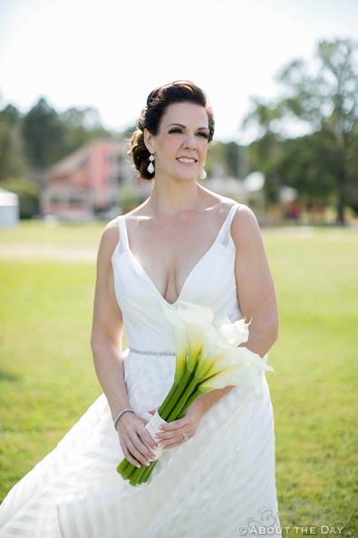 The Bride looks stunning in her wedding dress and flowers