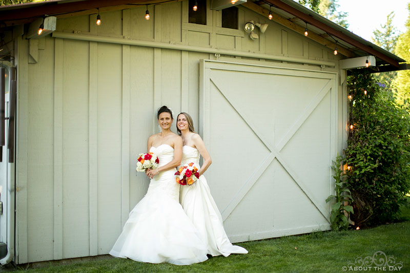 Brides pose with barn door