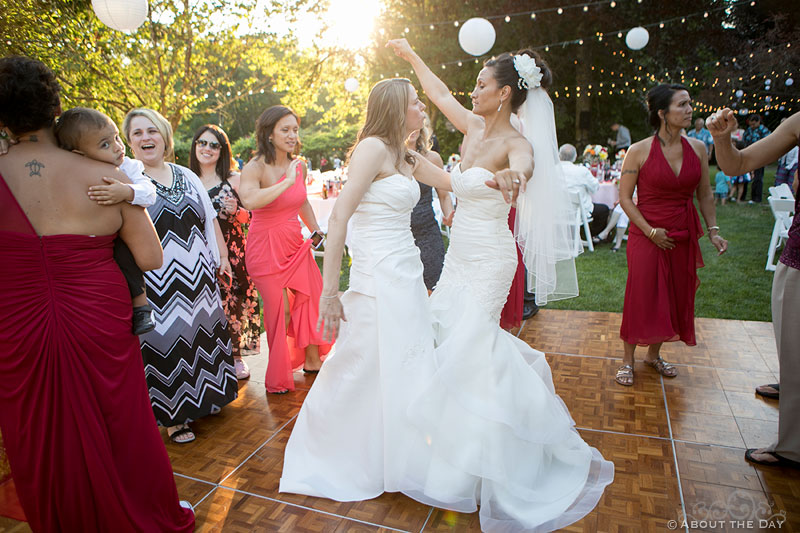 Brides dance together in setting sun