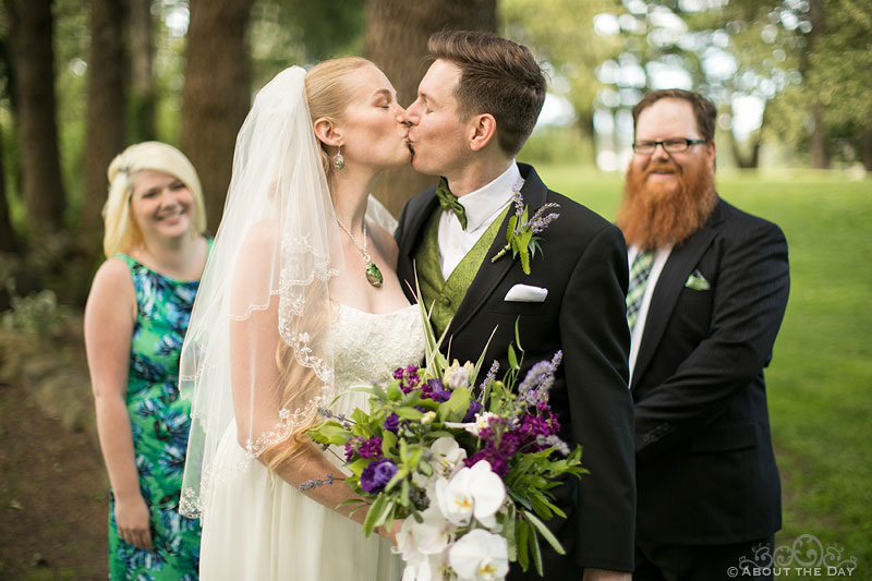 Bride and Groom kiss in front of their wedding party