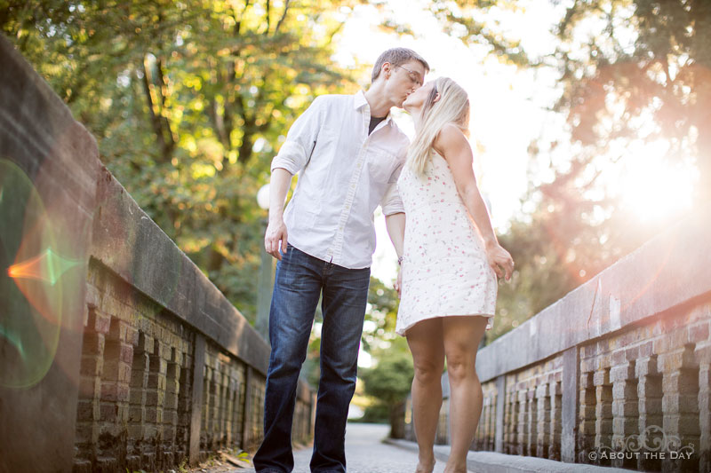 Engaged couple kiss on the Seattle arboretum foot bridge