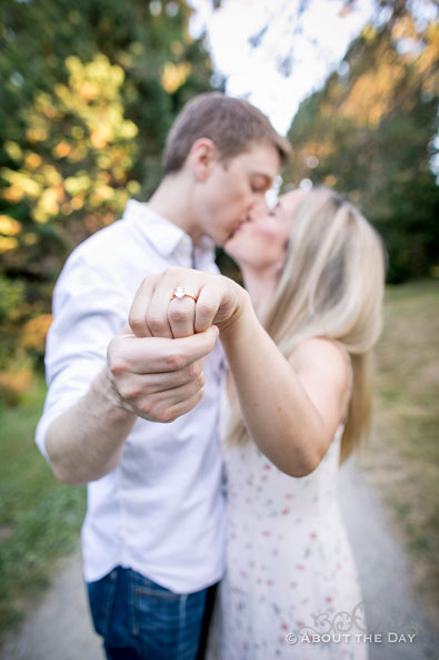 Alex & Andrew kiss and show her ring in the foreground