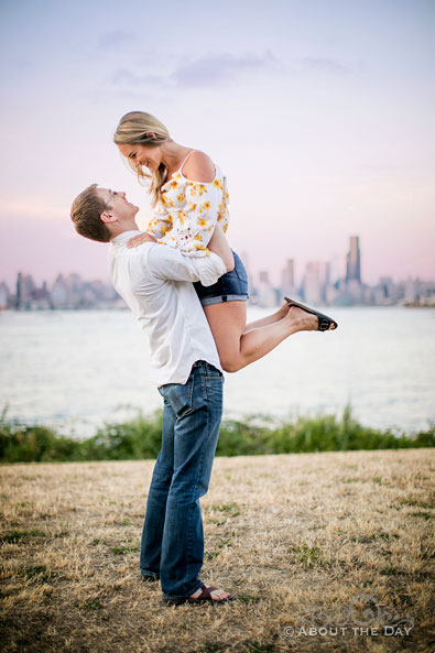 Andrew lifts Alex in the air during sunset at Alki Beach