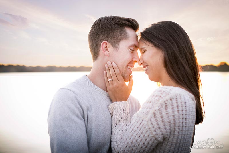 Engaged couple snuggles in for a kiss at sunset in Seattle