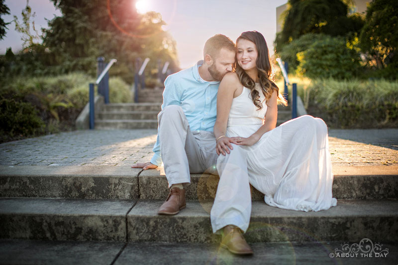 Eric & Ami sitting on cement steps at the Bremerton Marina during sundown