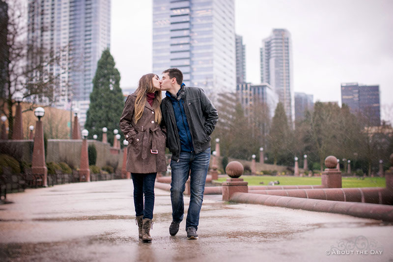 Will & Madelyn kiss while walking in the rain at Bellevue park