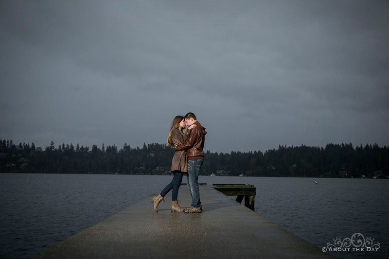 Will & Madelyn cuddle on the dock during darkening and stormy skies