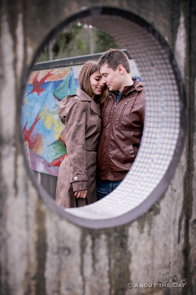 Will & Madelyn through a concrete and tile wall