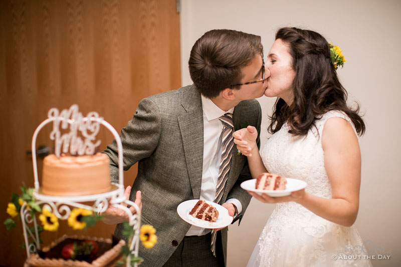 The Bride and Groom kiss during the cake cutting
