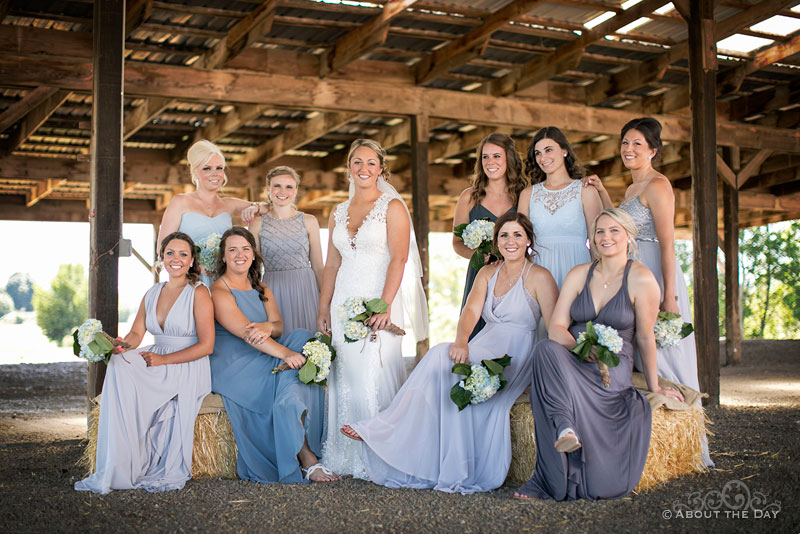 Karleigh and all her bridesmaids with hay bails