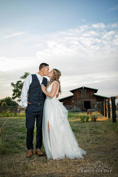Courtney and Douglas share a kiss in front of an old wood barn in Milton-Freewater, Oregon